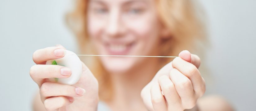 girl holding floss dentistry